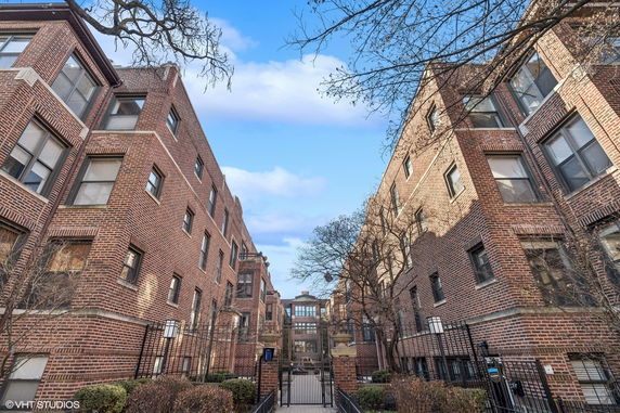 Front view of a multi-story brick apartment building complex.