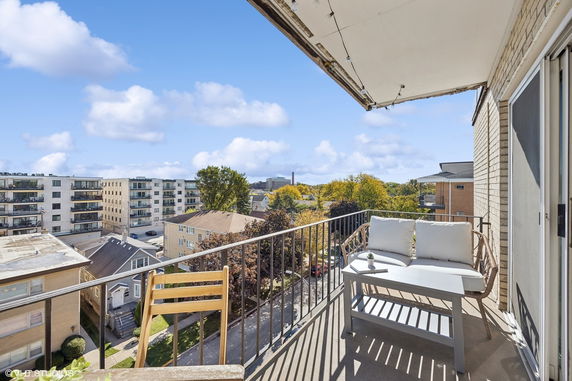 View from a balcony overlooking nearby residential and apartment buildings.