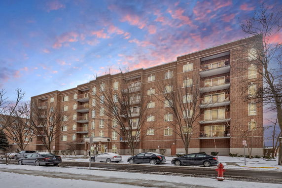 Front view of a multi-story apartment building with balconies.