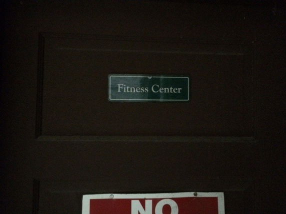 Door with a sign labeled 'Fitness Center'.