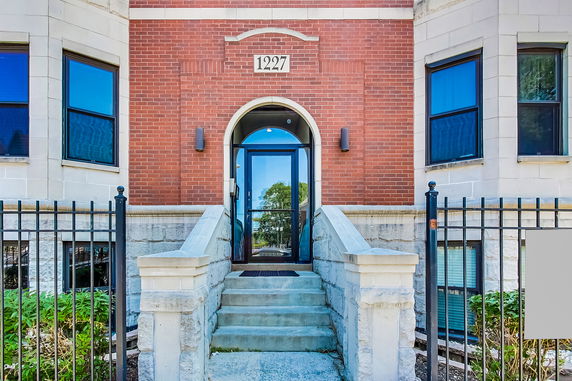 Front view of a multi-story brick building entrance.