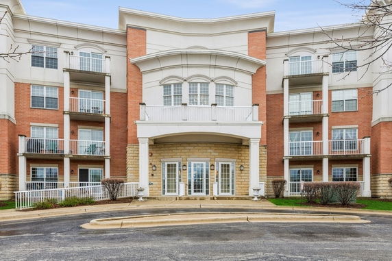 Front view of a multi-story residential building with balconies.