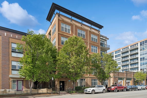 Front view of a multi-story brick apartment building.