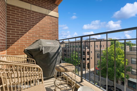 View from a balcony showing surrounding buildings and street.