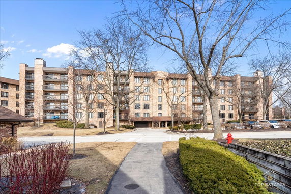 Front view of a multi-story residential building with balconies.