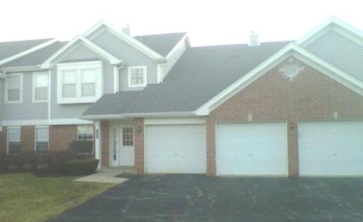 Front view of a two-story house with attached double garage.