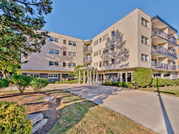 Front view of a multi-story residential building with balconies.