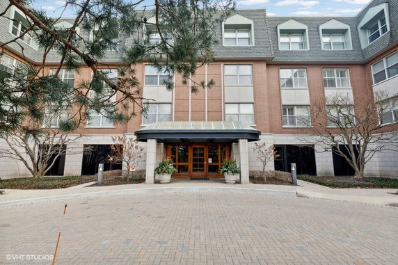 Front view of a multi-story building with a central entrance.