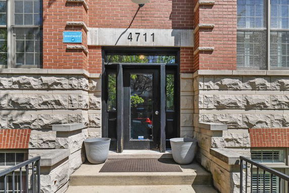 Front entrance of a brick building with stone accents.