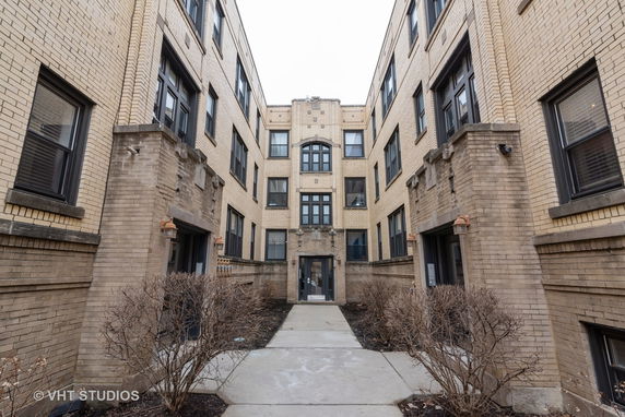 Front view of a three-story brick apartment building.