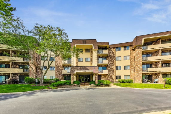 Front view of a multi-story apartment building with balconies.