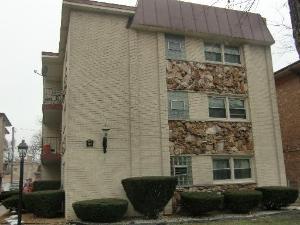 Front view of a multi-story building with brick and stone facade.