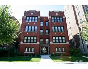 Front view of a multi-story brick apartment building.