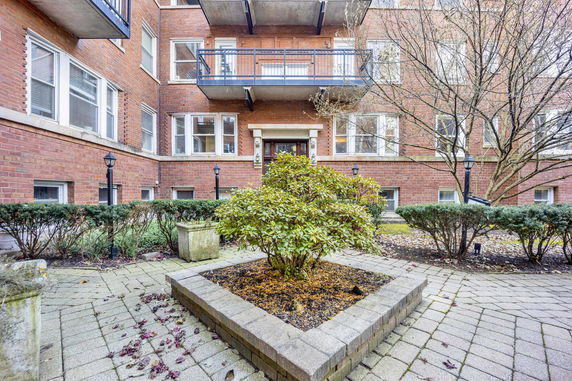 Front view of a multi-story brick building with balconies.