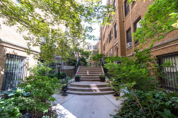 View of apartment buildings and entrance steps between two brick structures.