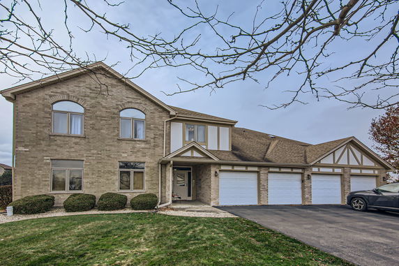 Front view of a two-story house with a three-car garage.