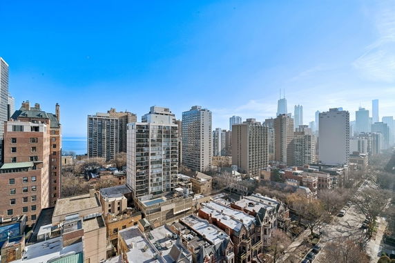 Wide angle view of a cityscape with high-rise buildings and a clear blue sky.