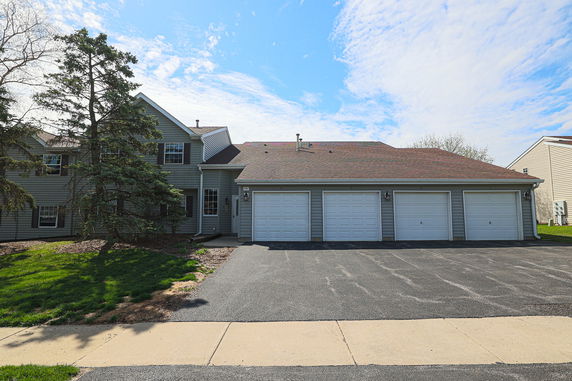 Front view of a two-story house with a triple garage.