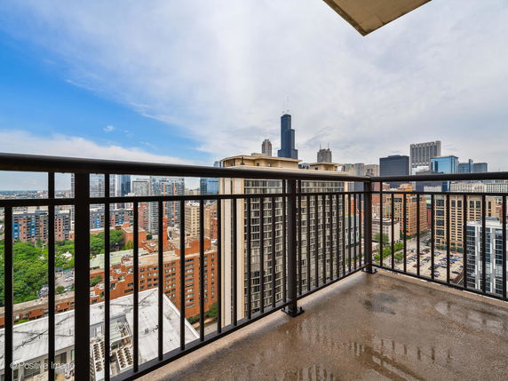 Panoramic view of city skyline from a balcony.