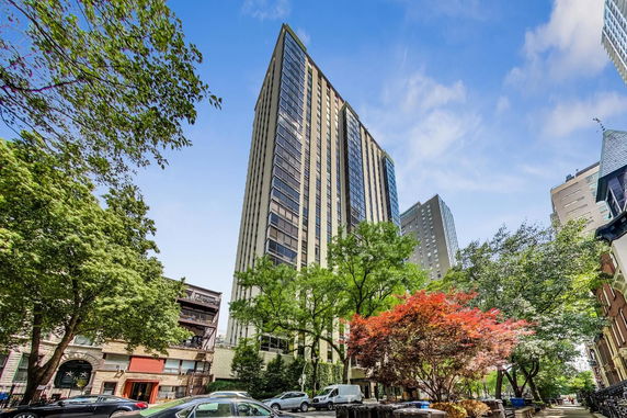 Front view of a tall modern high-rise building with glass windows.