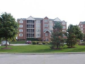 Front view of a multi-story apartment building with balconies.