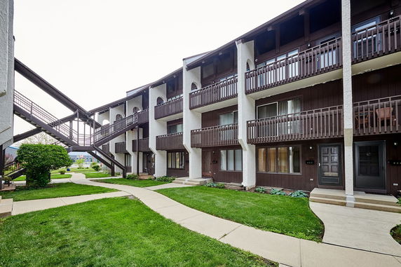 Front view of a multi-story apartment building with balconies.