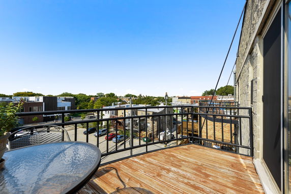 View from a balcony overlooking residential and commercial buildings.