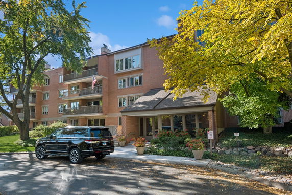 Front view of a multi-story brick building with balconies.