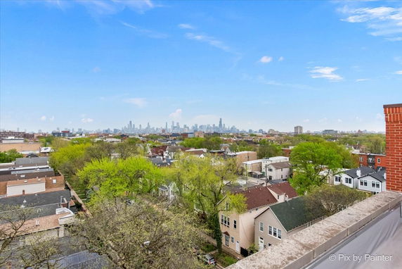 Panoramic view of a suburban area with a city skyline in the distance.