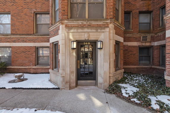 Front view of a brick apartment building entrance.