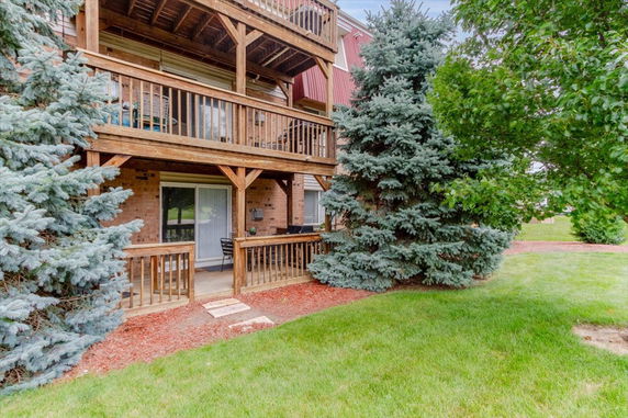 Front view of a multi-level building with wooden balconies.