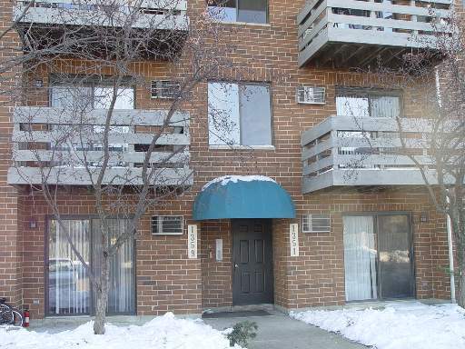 Front view of a multi-story brick building with multiple balconies.