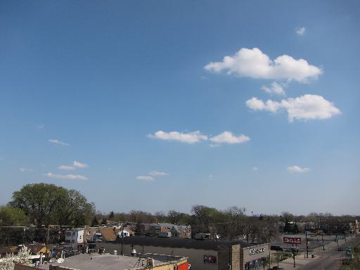Panoramic view of surrounding area with buildings and a clear blue sky.