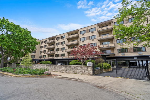 Front view of a multi-story apartment building with balconies.