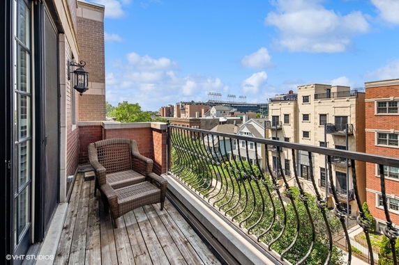 Balcony view overlooking surrounding buildings with a glimpse of distant landscape.