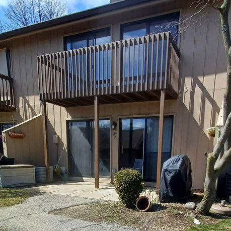 Front view of a two-story house with a balcony.