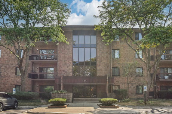 Front view of a multi-story brick building with balconies.
