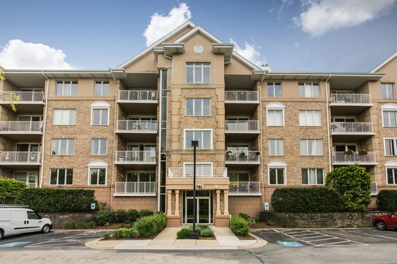 Front view of a multi-story apartment building with balconies.