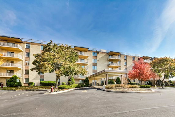 Front view of a multi-story residential building with balconies.