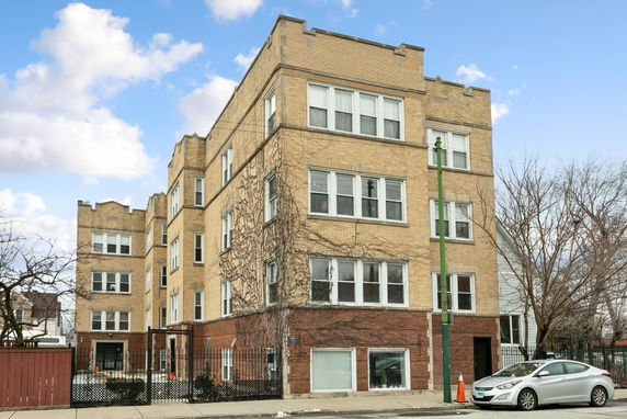 Front view of a four-story building with brick exterior.