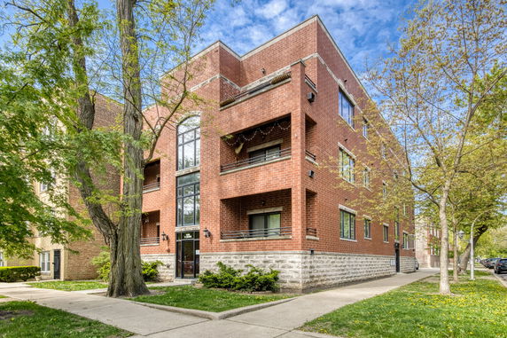 Front view of a three-story brick apartment building.