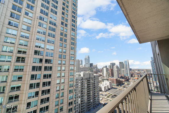 Panoramic city view from a building balcony.