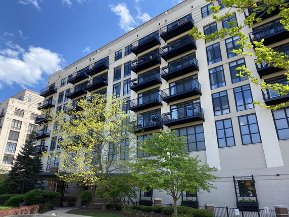 Front view of a multi-story residential building with balconies.