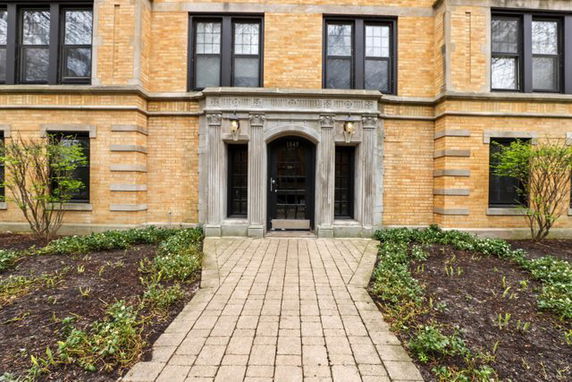 Front view of a brick building with a central entrance.