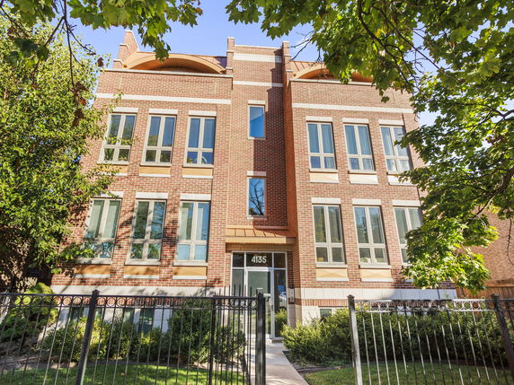 Front view of a modern multi-story brick building.