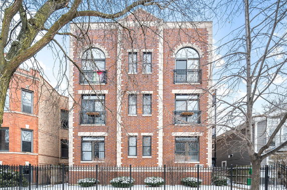 Front view of a multi-story brick apartment building.