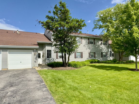 Front view of a two-story house with attached garage.