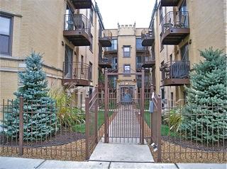 Front view of a multi-story apartment building with balconies.