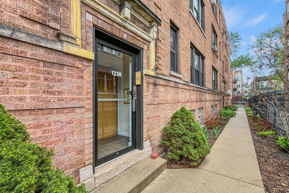 Front view of a brick apartment building entrance.