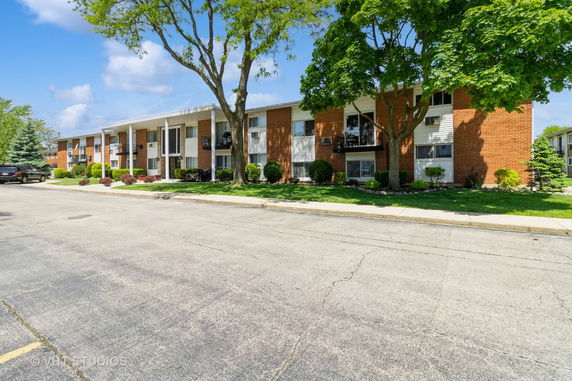 Front view of a two-story brick apartment building.